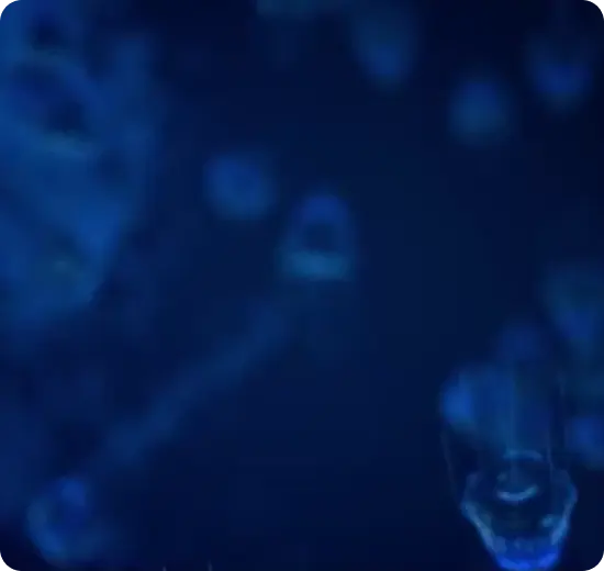Faint blue energy cells glowing in deep navy darkness, illustrating Roshni's low power draw